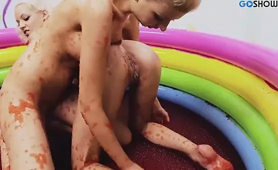 Blonde and brunette enjoy intimate playtime in the red bath of an alluring inflatable pool